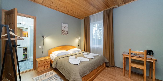 Double room with one large bed and a sofa
